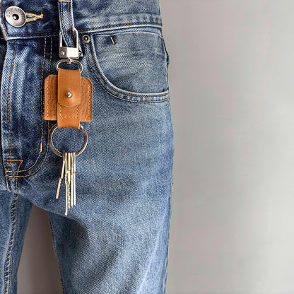  life style photo of AirTag keychain with a convenient snap hook and keyring attachment made from Italian full-grain vegetable-tanned leather in brown color