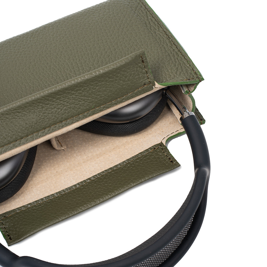 Olive green leather AirPods Max case with adjustable shoulder strap shown flat lay, minimalist protective cover for Apple headphones