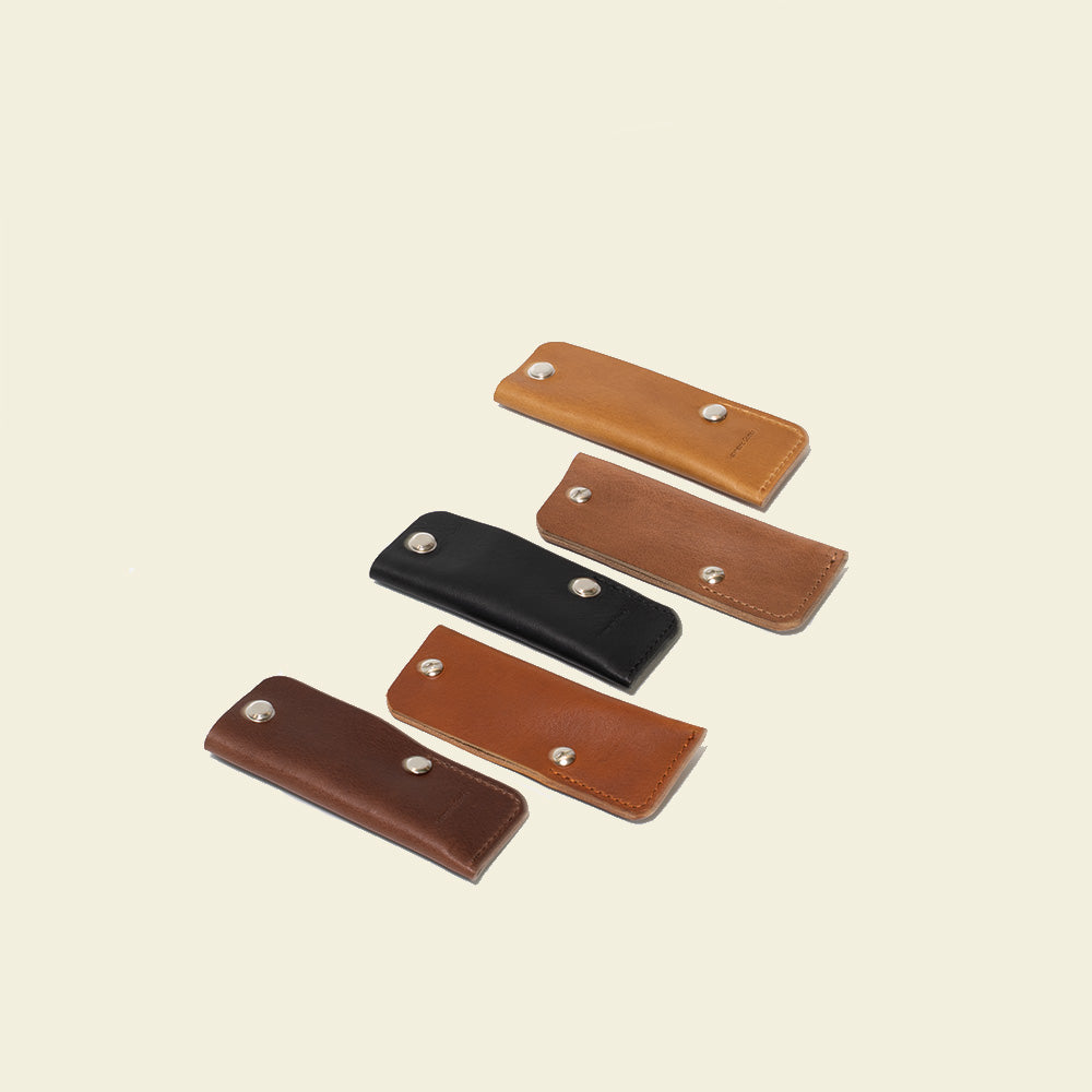 photo of the Minimalist air tag keyholder collection in camel brown black tan and mahogany colors