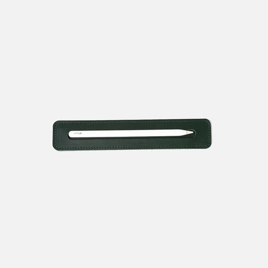 Forest green leather tray holding a white Apple Pencil, viewed from above