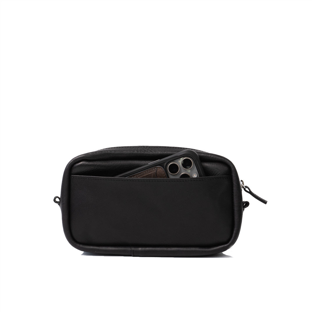 Open top view of black leather organizer bag with smartphone and wallet inside, illustrating the internal capacity and organization features