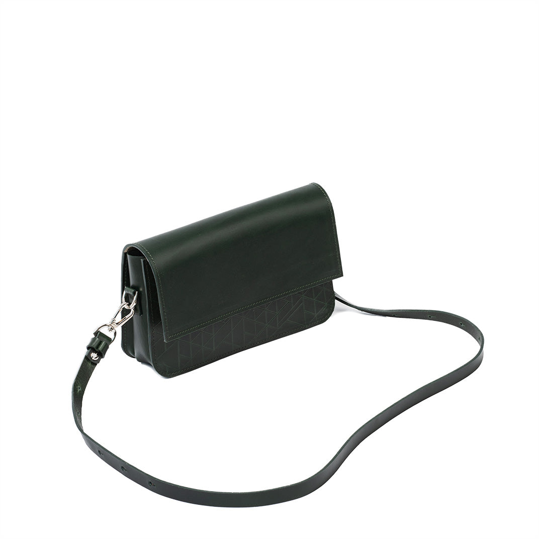 Elegant dark green shoulder bag with adjustable strap and embossed geometric pattern.