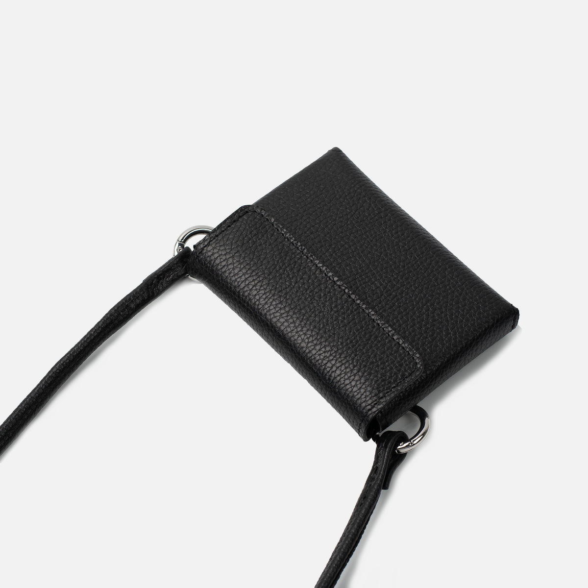 Black DUO Sleeve 1.0 in Italian pebbled leather with shoulder strap, angled view