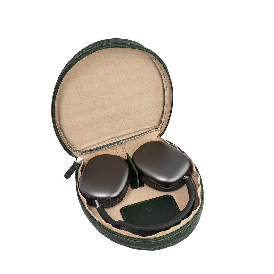 Open forest green leather AirPods Max case with headphones inside, revealing the soft lining, storage pocket, and spacious design.