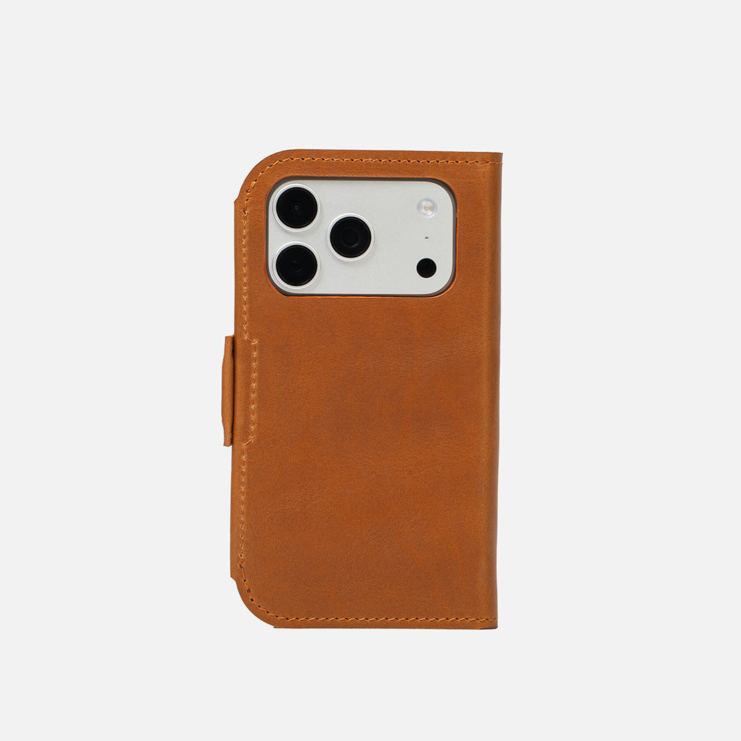iPhone 17 Pro Classic 5.1 leather folio in tan — closed back view with precise camera cutout and low-profile magnetic strap; full-grain Italian leather, MagSafe-ready