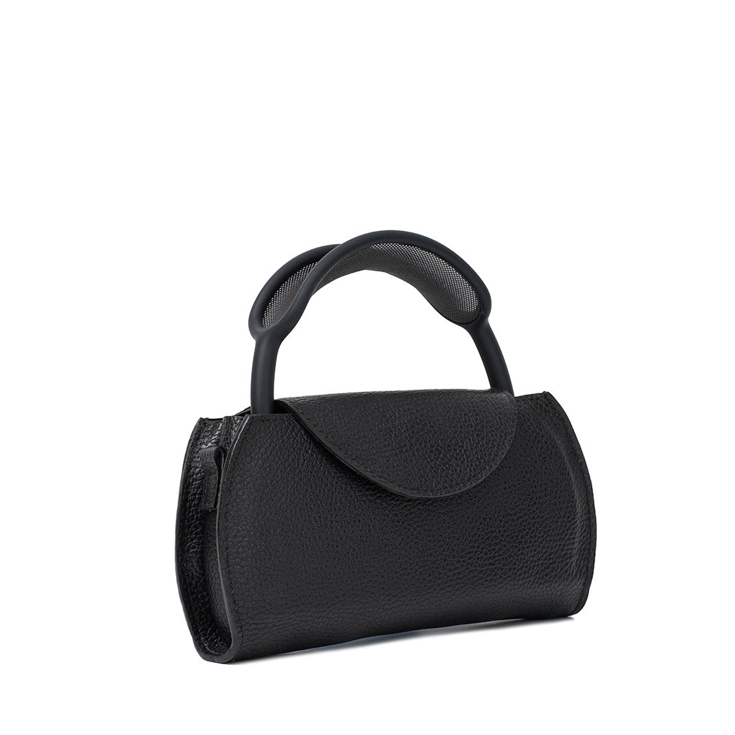Luxury AirPods Max case like handbag in black leather – angled view showing compact silhouette and sculpted handle
