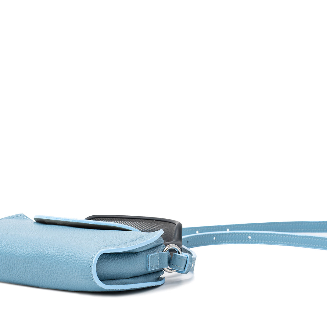 Side view of sky blue leather AirPods Max case with adjustable strap and rounded flap, minimalist protective design