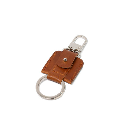 AirTag keychain with a convenient snap hook and keyring attachment made from Italian full-grain vegetable-tanned leather in tan cognac brown color