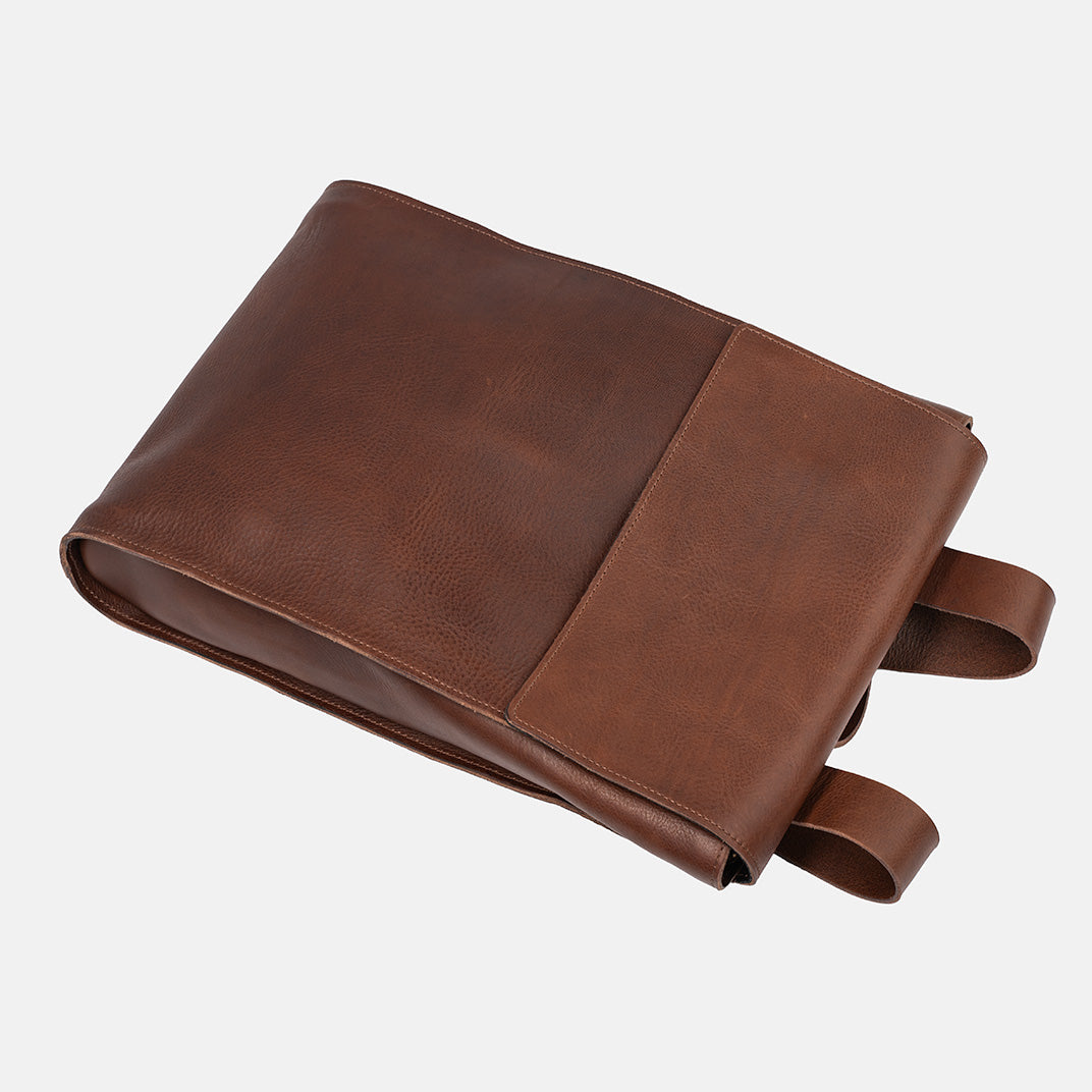 Leather backpack in mahogany, top view highlighting minimalist design, perfect for designers and men