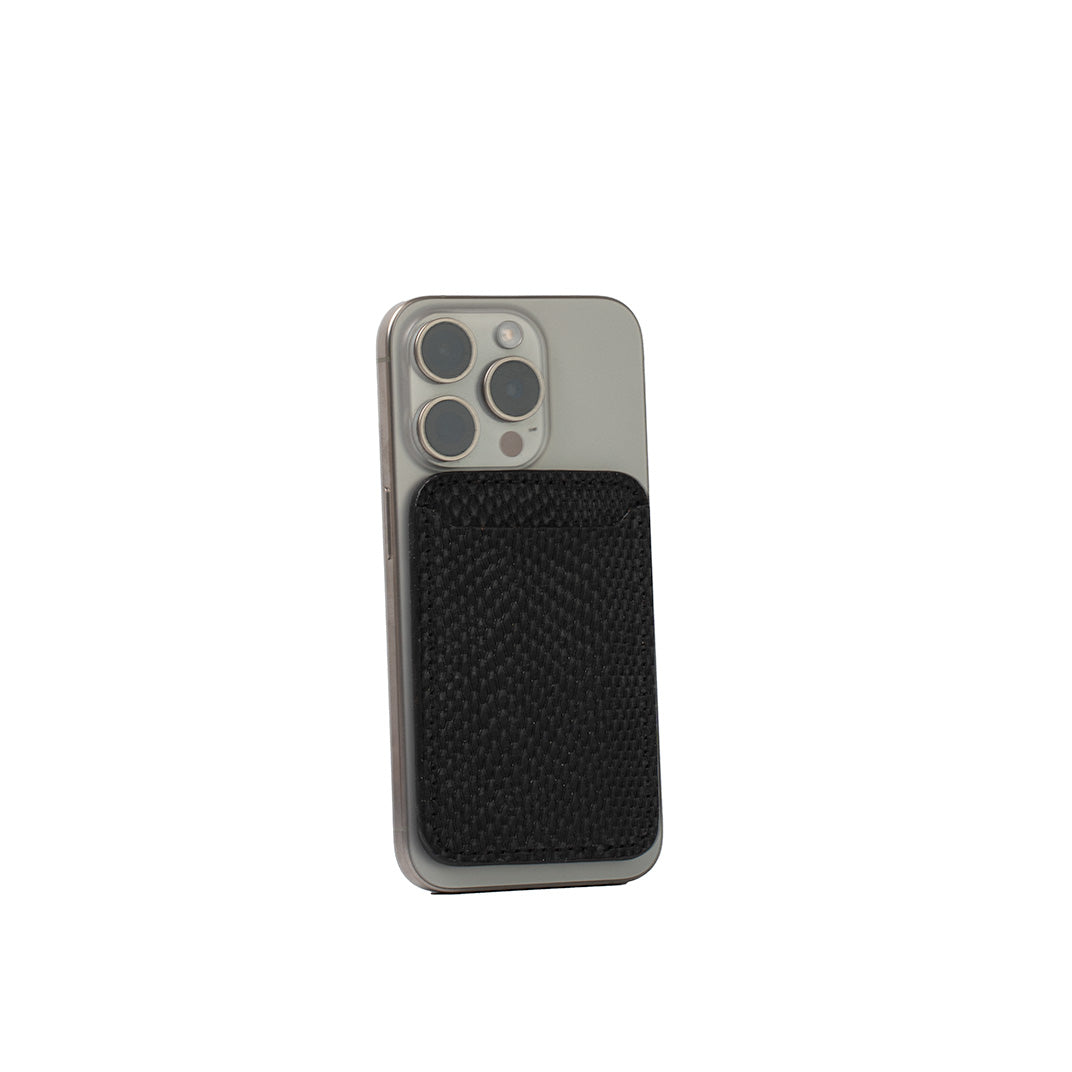 Black leather MagSafe wallet with embossed snake print on iPhone 16 Pro, vegetable-tanned leather, minimalist design