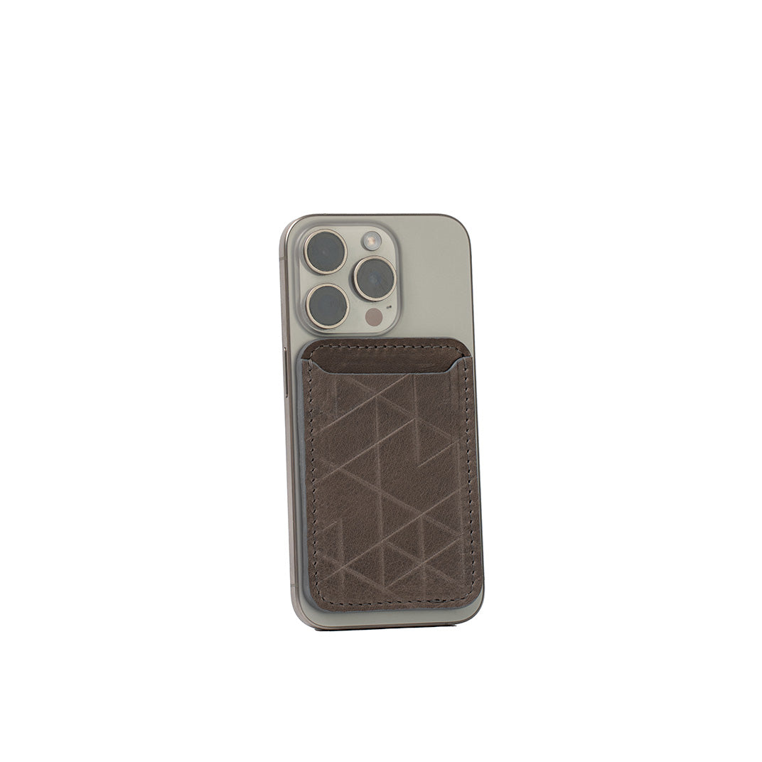 Gray leather MagSafe wallet for iPhone with handcarved Vectors geometric design, vegetable-tanned Italian leather, handcrafted, shown on iPhone
