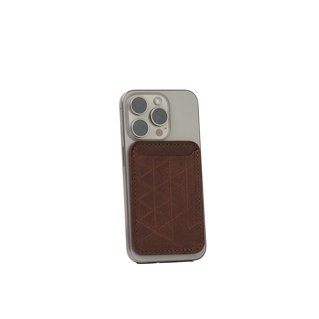 Mahogany leather MagSafe wallet for iPhone with handcarved Vectors geometric design, vegetable-tanned Italian leather, handcrafted, shown on iPhone
