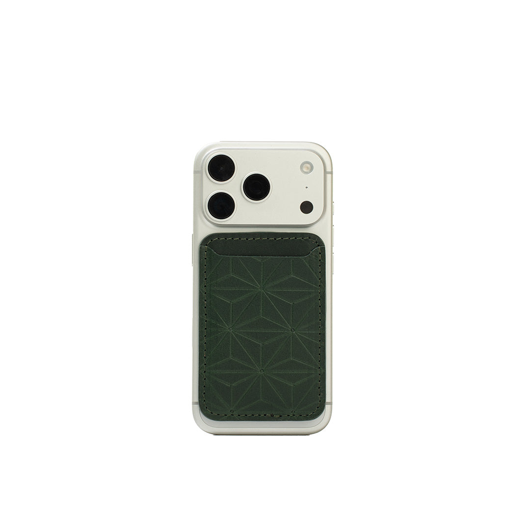 MagSafe leather wallet in Forest Green, handcarved Geometric Flower pattern on iPhone 17 Pro — Italian veg-tanned leather, holds 2–3 cards, Apple-approved magnet