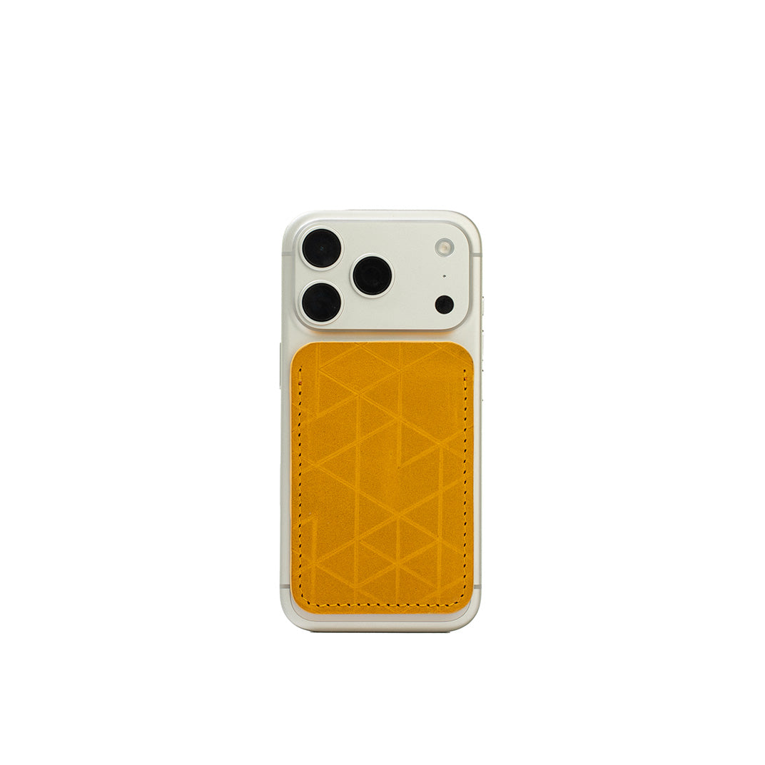 MagSafe leather wallet in yellow “Vectors” on iPhone — full-grain Italian veg-tanned leather, holds 2–3 cards, Apple-approved strong magnet