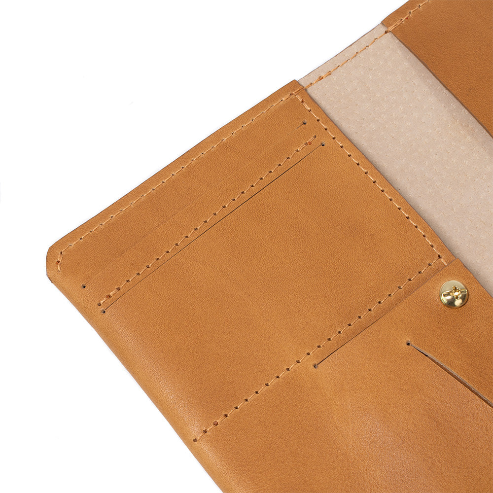 Geometric Goods' smart and trackable AirTag passport holder, made from premium light brown Italian leather