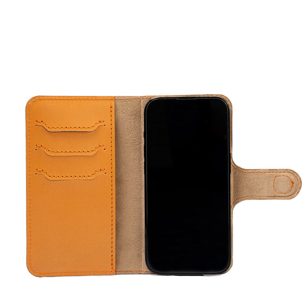 iPhone 14 folio case with MagSafe made from top-grain vegetable tanned leather in orange color by Geometric Goods leather workshop