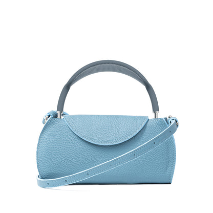 Sky blue leather AirPods Max case with adjustable shoulder strap, minimalist rounded flap design for stylish headphone protection