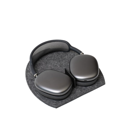 AirPods Max headphones on Rest Station 2.0 in grey wool felt – stand with low power mode activation