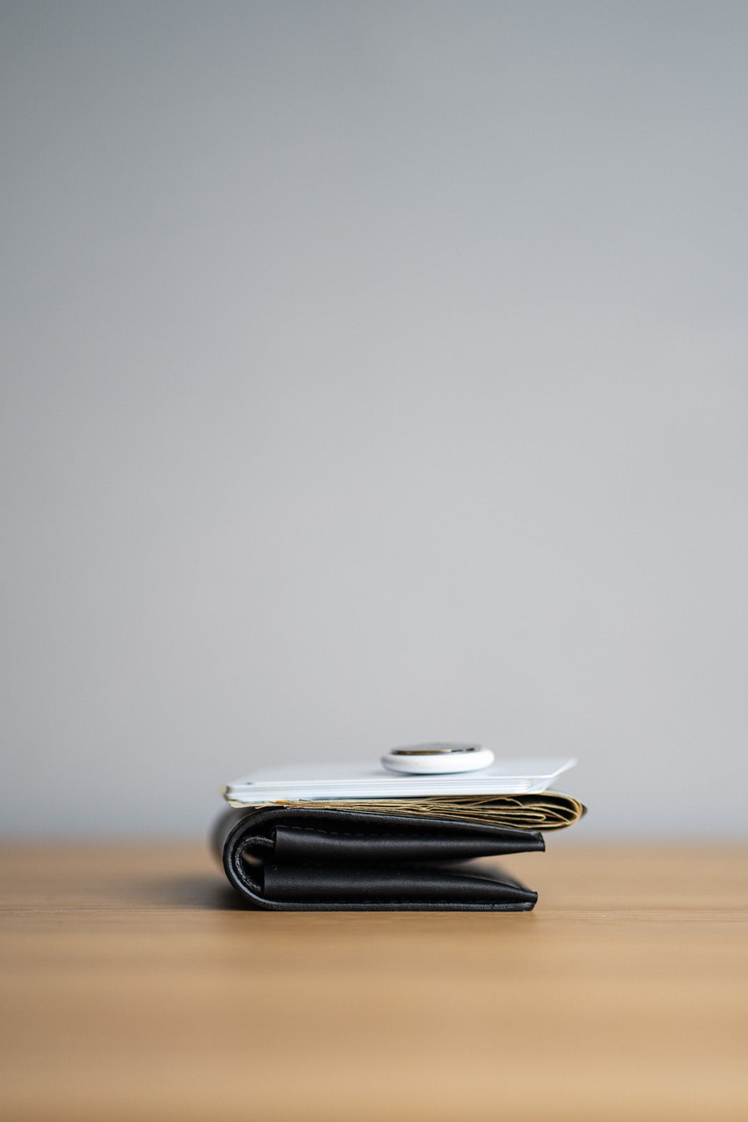 Leather billfold airtag wallet showing slim side profile.