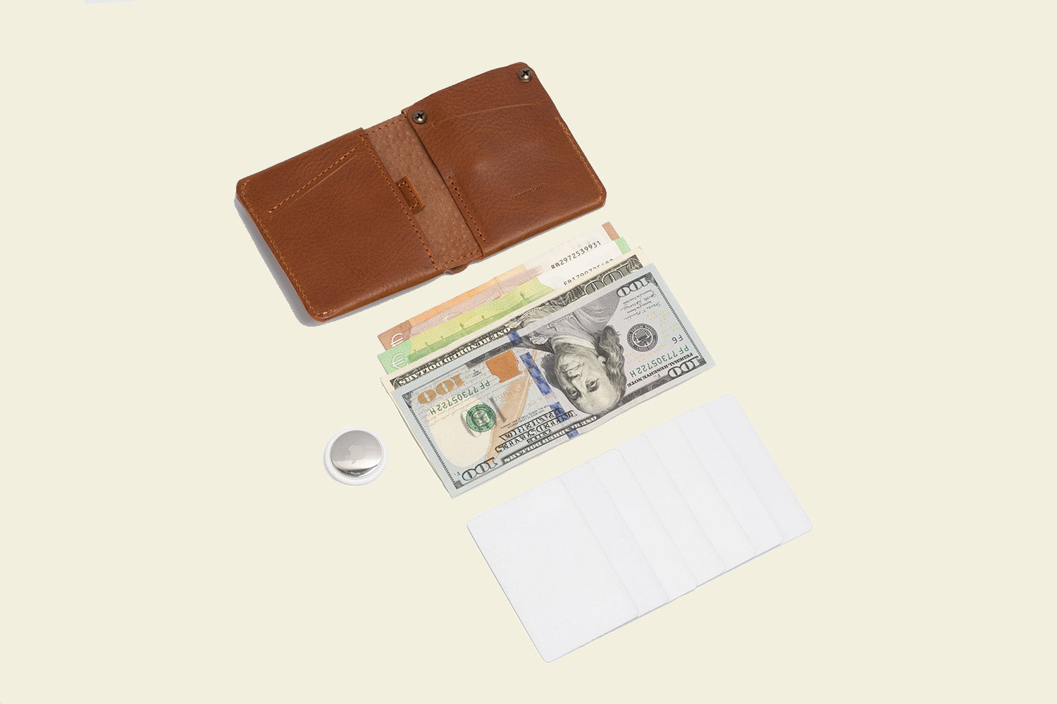 the photo of the best cognac brown men's and women's bi-fold wallet with airtag wich hold up to 7 cards paper bills and apple's airtag in a secret slot