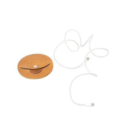 Apple cord organizer "The Moon Universal" open with charger cord, featuring snap-button closure and premium leather design, ideal for managing iPhone and Apple charger cables.