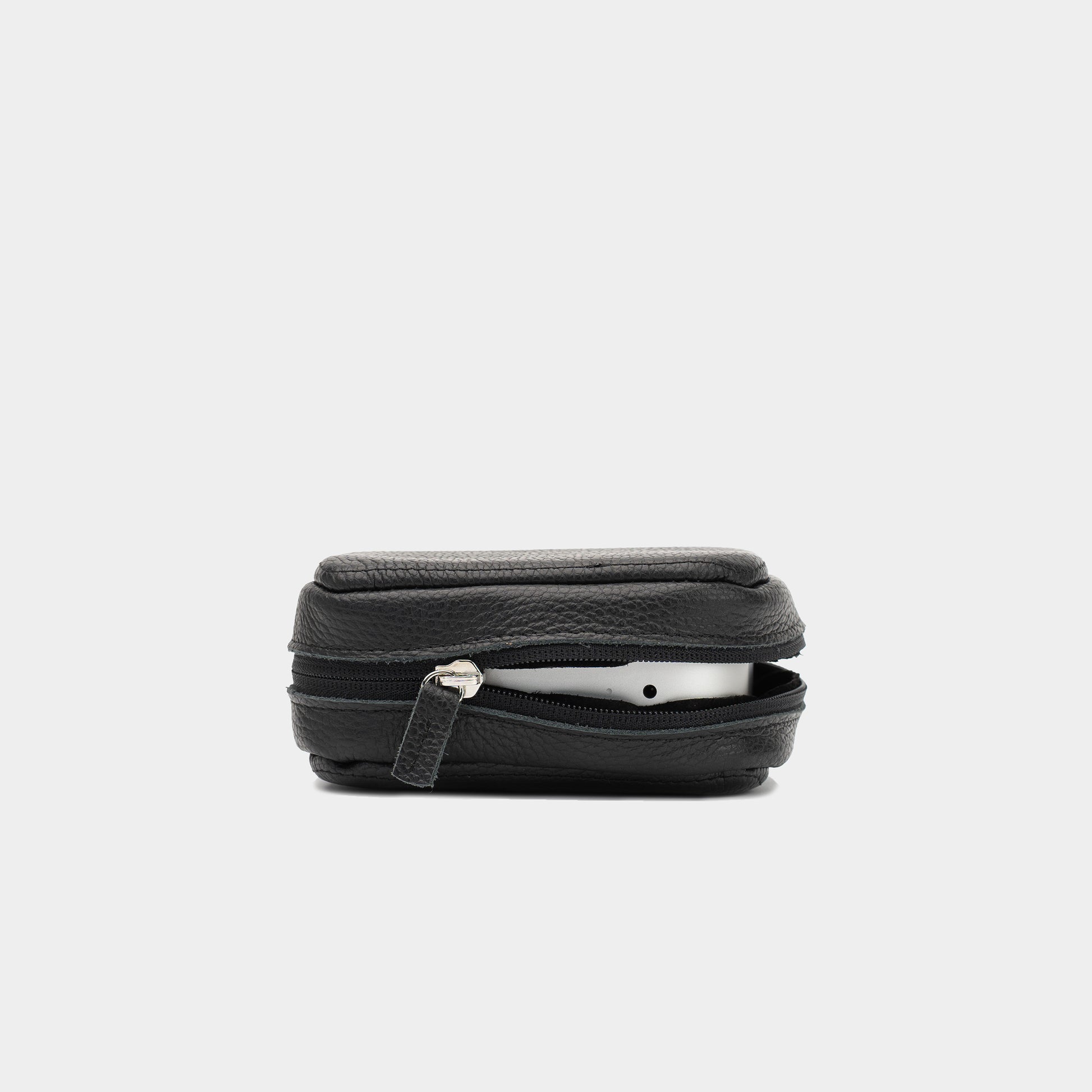 Side view of black leather Mac Mini case partly unzipped, with the device visible inside