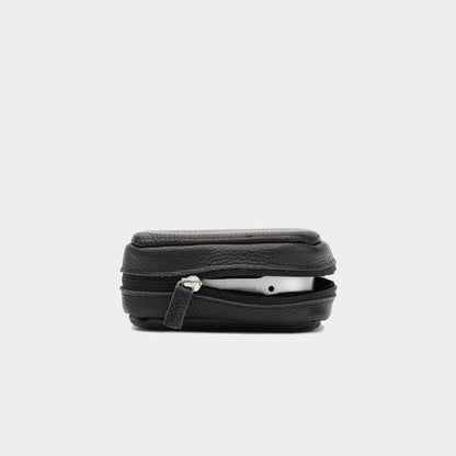 Side view of black leather Mac Mini case partly unzipped, with the device visible inside