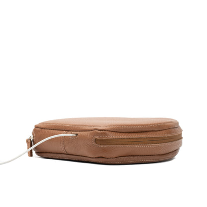Side view of brown AirPods Max leather case with zipper and cable opening visible