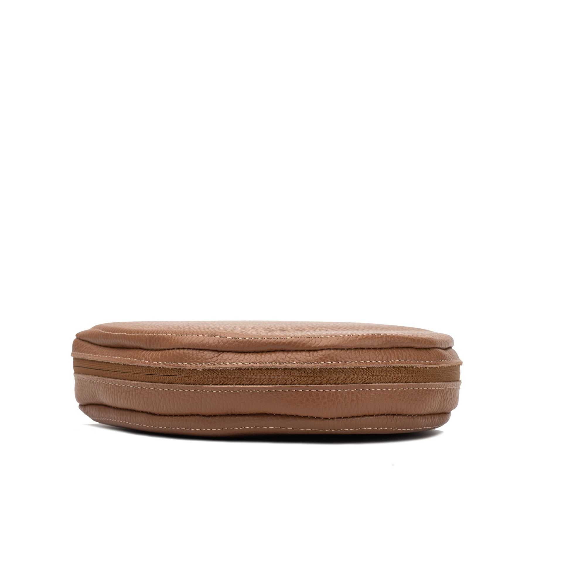 Slim side profile of brown AirPods Max leather case with zipper and stitched edges visible