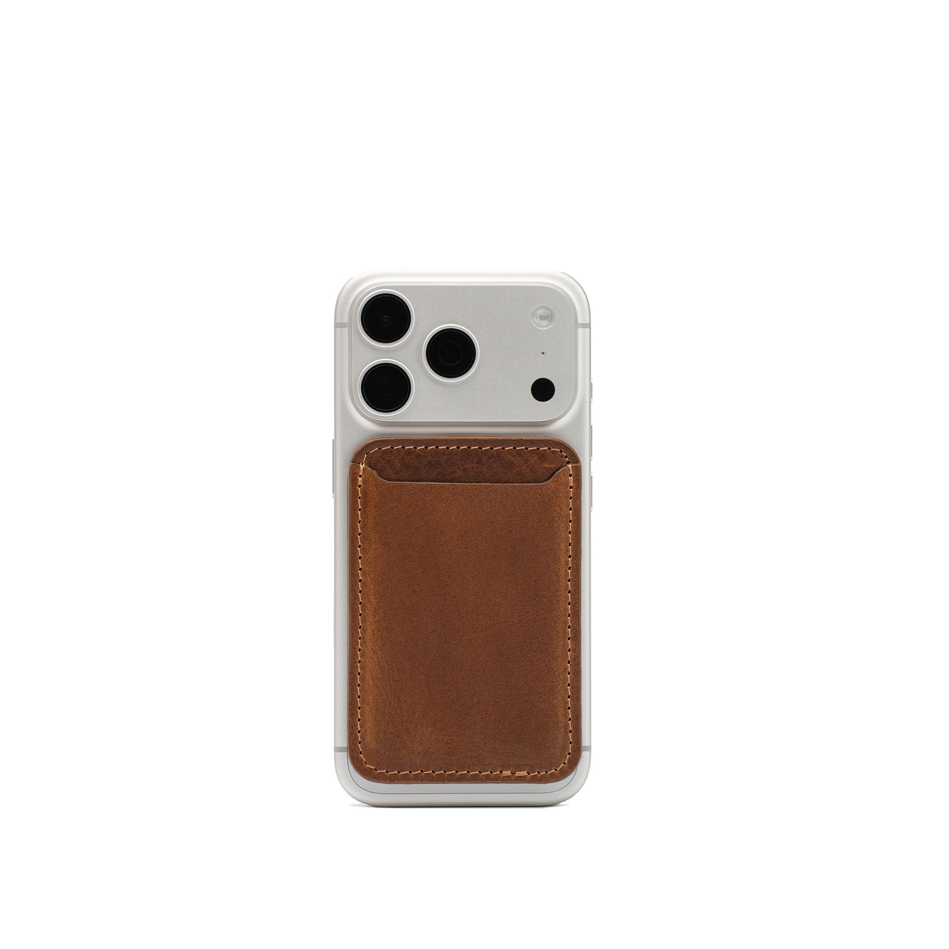 Brown Classic full-grain leather MagSafe wallet attached to a white iPhone