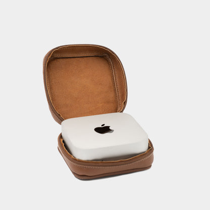 Open brown flat-grain leather Mac Mini case with soft interior lining and Apple Mac Mini placed inside