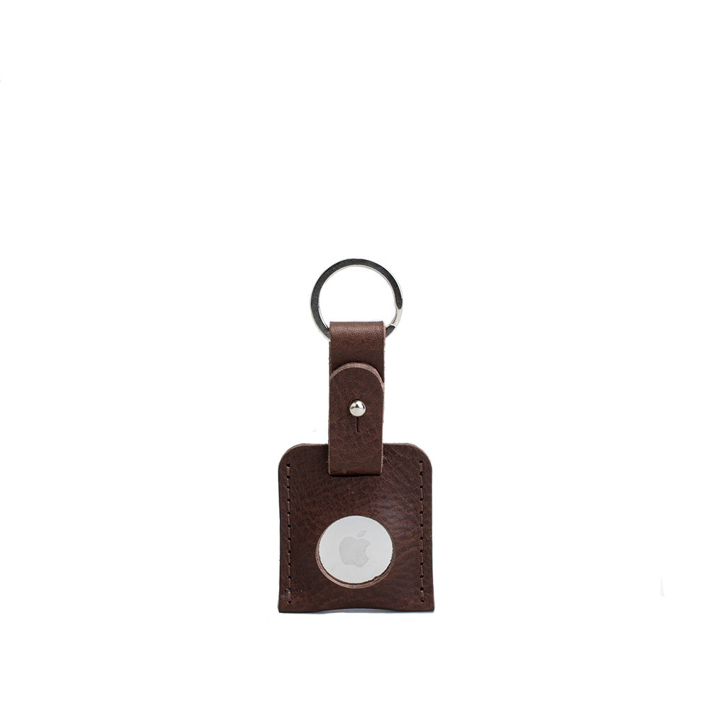 Brown small full-grain leather keyring holding an Apple AirTag