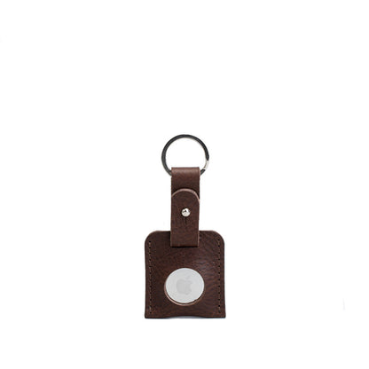 Brown small full-grain leather keyring holding an Apple AirTag