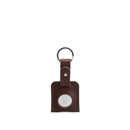 Brown small full-grain leather keyring holding an Apple AirTag