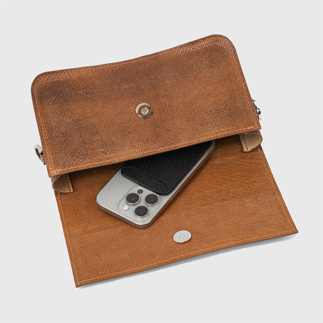 Close-up of brown snake print leather purse showing clasp closure and high-quality stitching