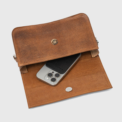 Close-up of brown snake print leather purse showing clasp closure and high-quality stitching