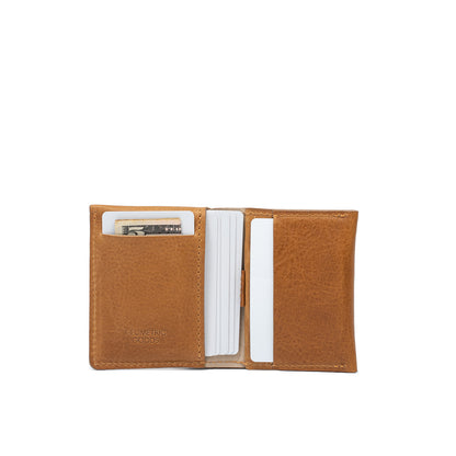 Open view of camel leather AirTag card wallet holding multiple cards and cash.