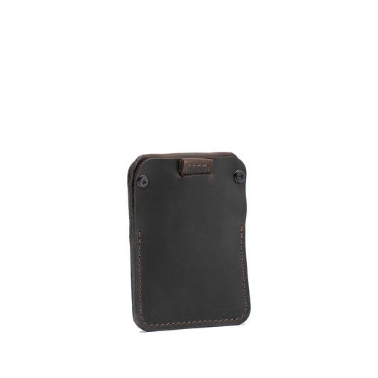 Chocolate brown Leather Wallet for AirTag – The Minimalist 1.0 in front three-quarter view with pull tab and screw closure