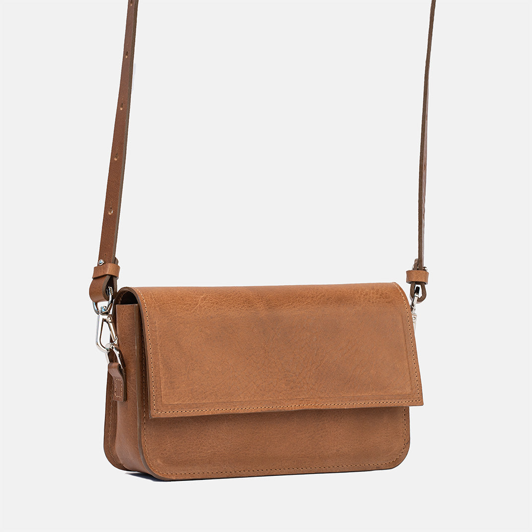 Brown leather shoulder bag with structured design, adjustable strap, and metal clasp closure