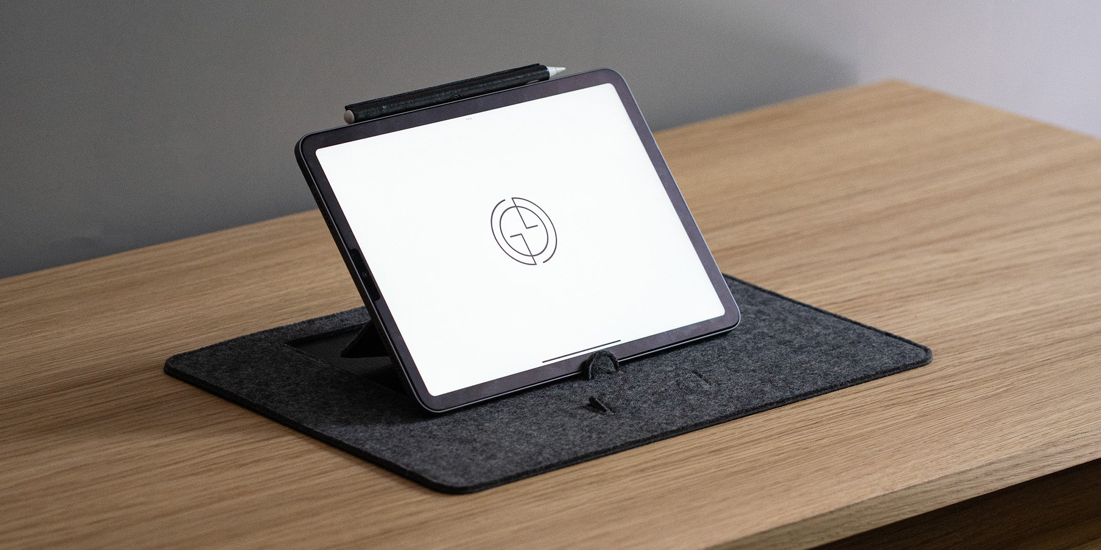 Close-up of desktop iPad stand in grey wool felt with Apple Pencil – elegant tablet holder for desk setup