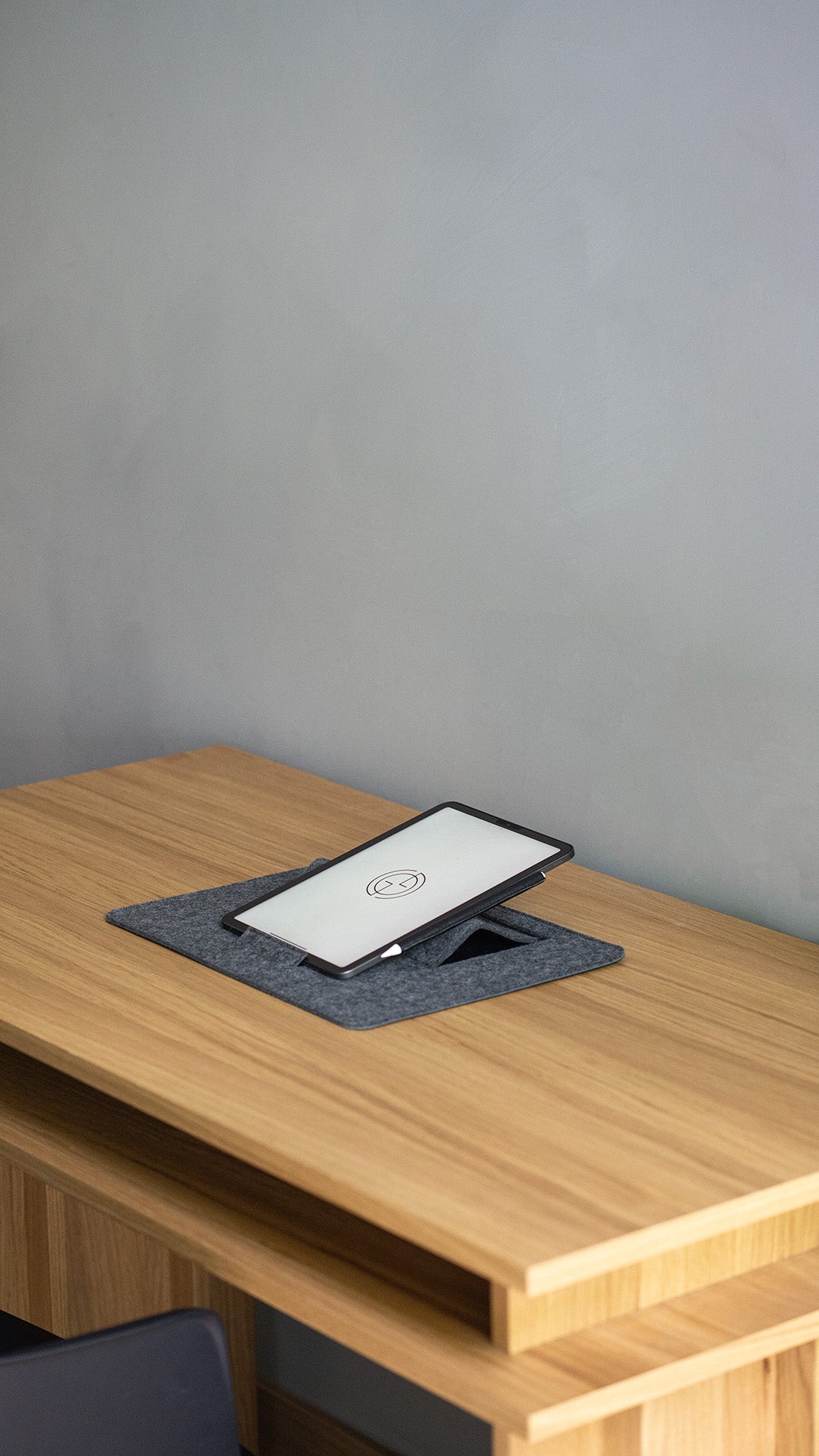 iPad on grey wool felt desktop stand with Apple Pencil – creative tablet holder for drawing and design work