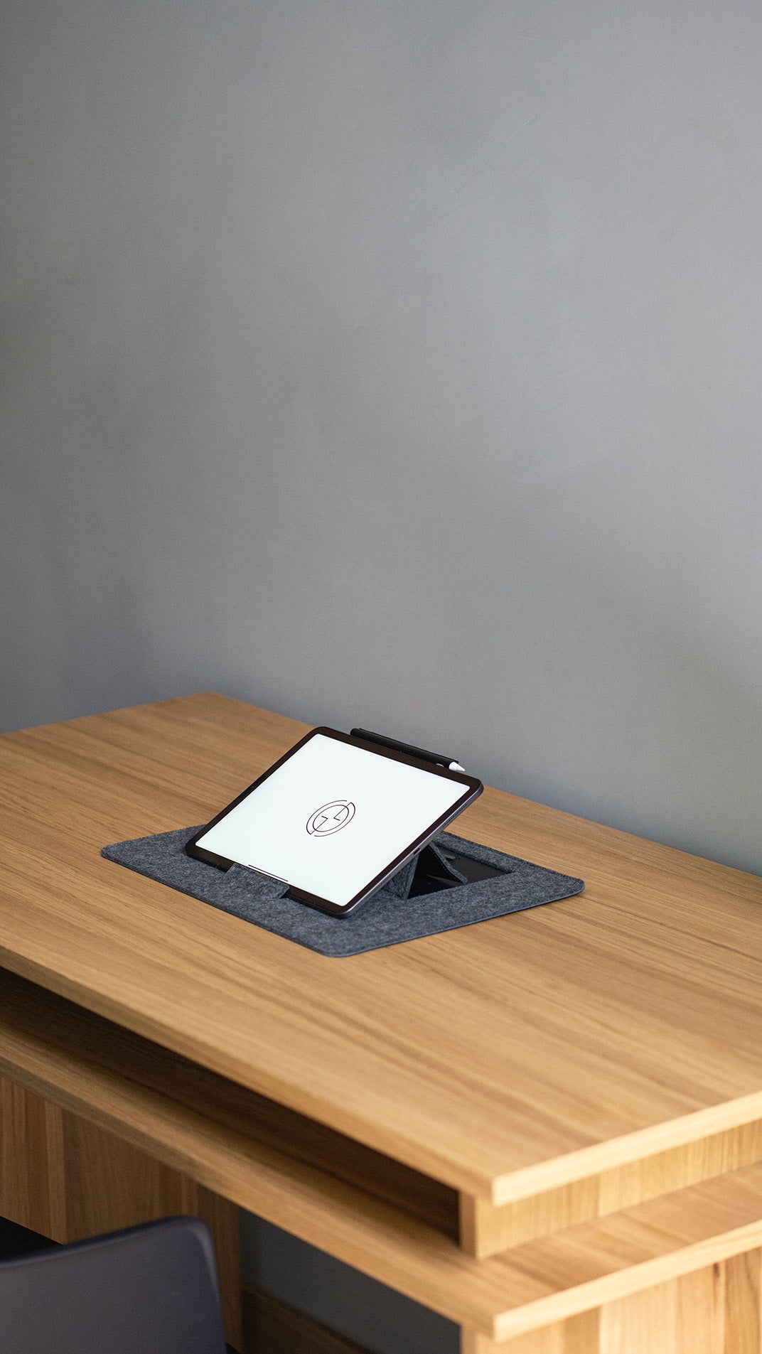 Minimalist iPad desk setup with desktop stand in grey wool felt – modern workspace accessory
