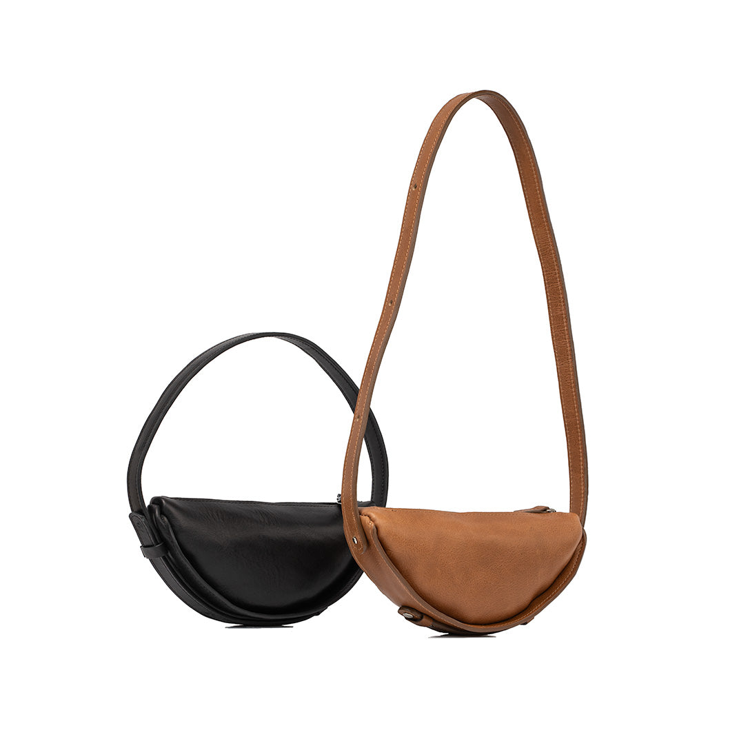 Elegant black and brown leather half-moon bags showcasing unique design and soft texture