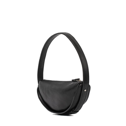 Elegant black leather crescent bag showcasing its unique side profile and soft texture