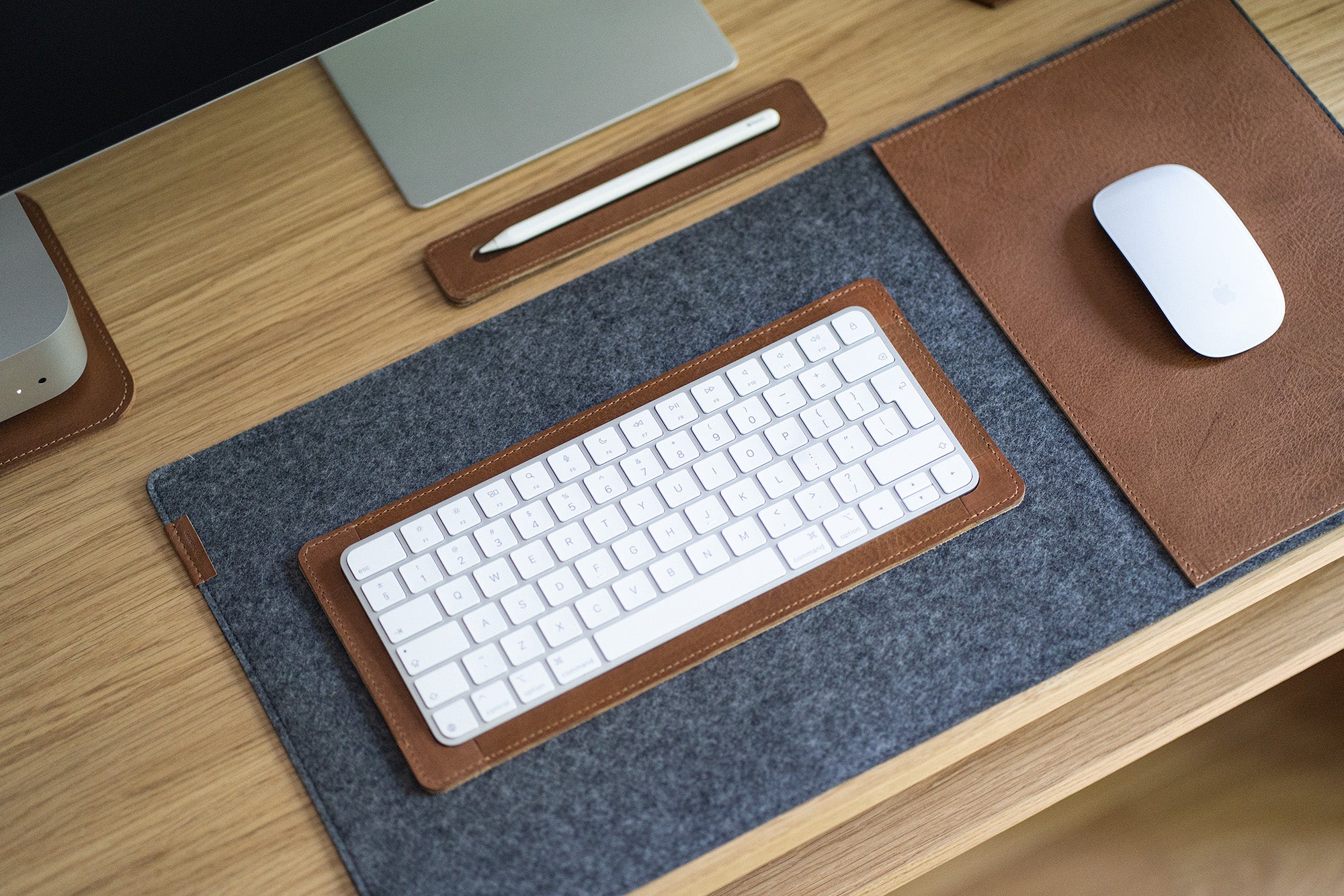 Felt desk pad with leather mouse insert and matching keyboard tray; Magic Mouse and Apple Pencil tray.