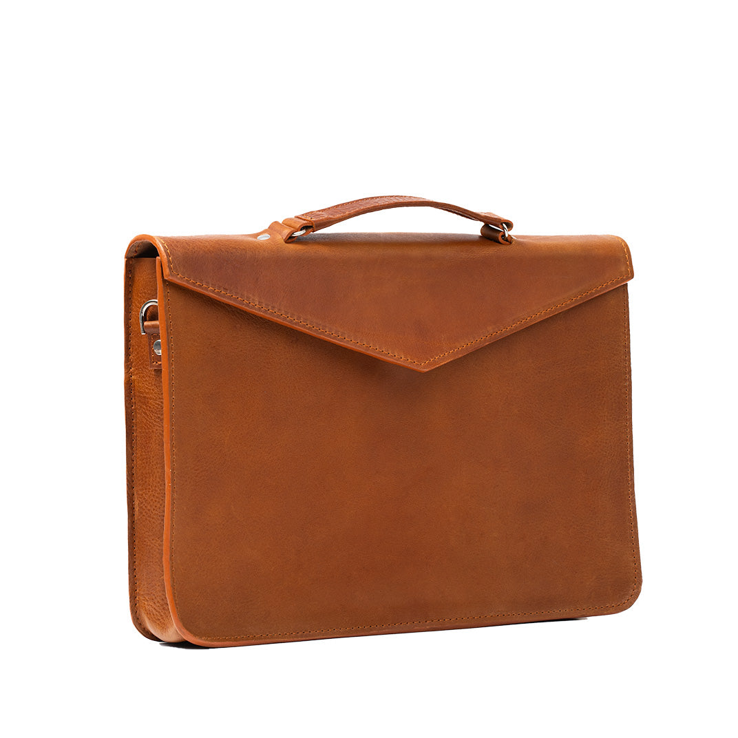 Classic tan leather briefcase for women, designed as a sleek laptop bag with durable leather, providing elegance and functionality.