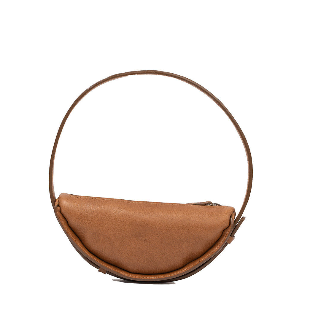 Front view of the stylish brown leather half-moon bag, highlighting its spacious interior and unique design