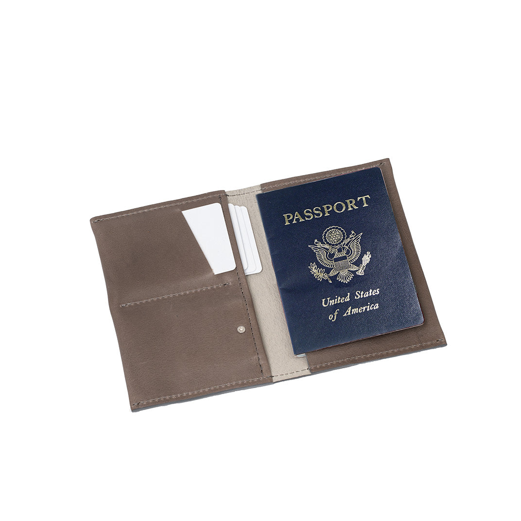Gray leather AirTag passport holder 2.0 featuring a sleek and modern design