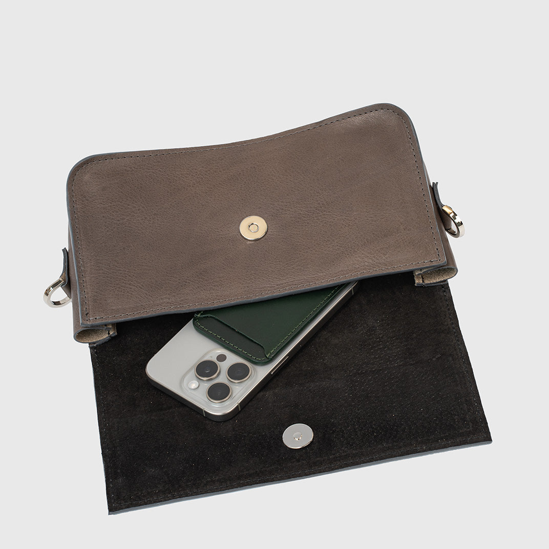 Detailed view of gray leather purse with secure clasp closure