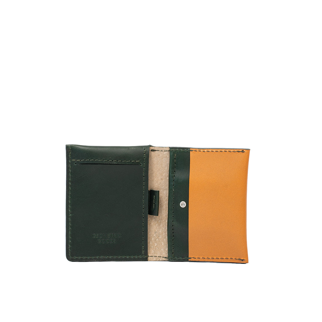 Open view of green and deep saffron leather AirTag card wallet with card slots and secure pocket